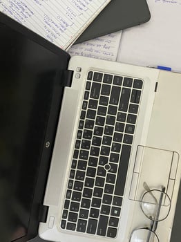 laptop with books papers and glasses for business or work background photo