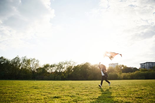 Beautiful sunlight.,. Happy little girl is playing with kite on the summer field photo