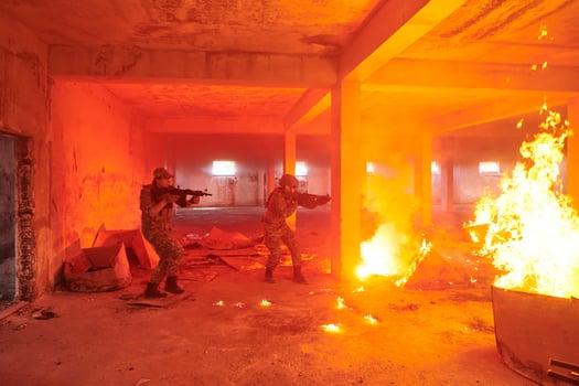 A group of professional soldiers bravely executes a dangerous rescue mission, surrounded by fire in a perilous building. photo