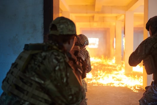 A group of professional soldiers bravely executes a dangerous rescue mission, surrounded by fire in a perilous building. photo