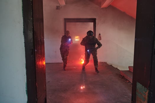 A group of professional soldiers bravely executes a dangerous rescue mission, surrounded by fire in a perilous building. photo