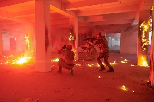 A group of professional soldiers bravely executes a dangerous rescue mission, surrounded by fire in a perilous building. photo