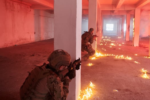A group of professional soldiers bravely executes a dangerous rescue mission, surrounded by fire in a perilous building. photo