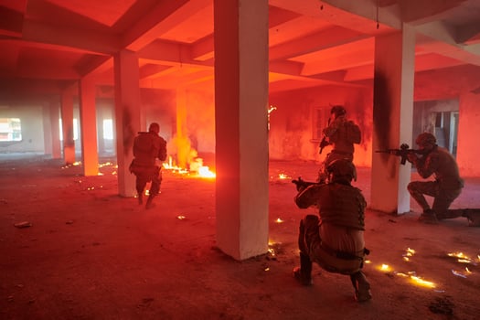 A group of professional soldiers bravely executes a dangerous rescue mission, surrounded by fire in a perilous building. photo