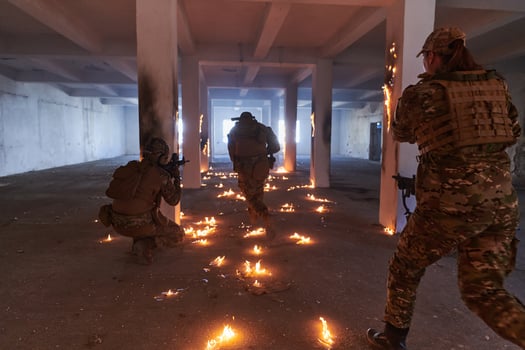 A group of professional soldiers bravely executes a dangerous rescue mission, surrounded by fire in a perilous building. photo