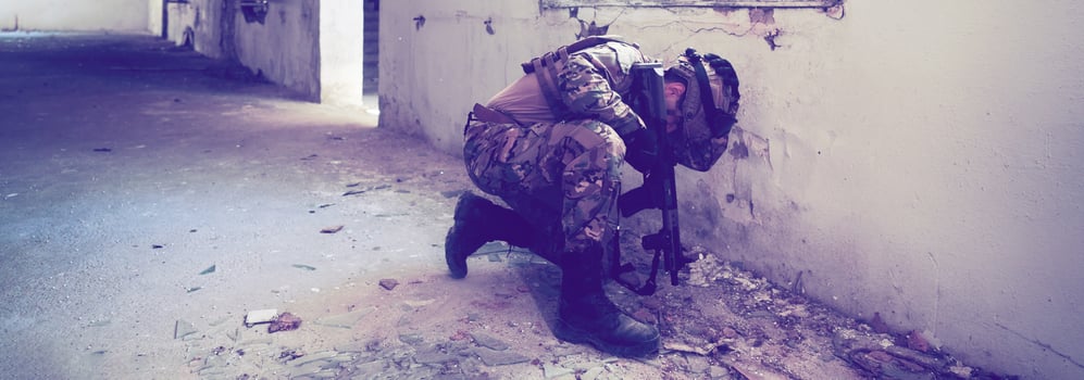 A professional soldier carries out a dangerous military mission in an abandoned building photo