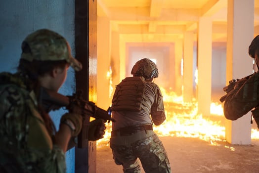 A group of professional soldiers bravely executes a dangerous rescue mission, surrounded by fire in a perilous building. photo