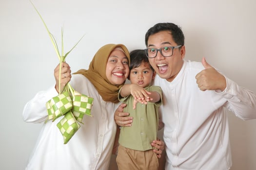 happy asian muslim family making ketupat together at home before eid mubarak isolated background photo