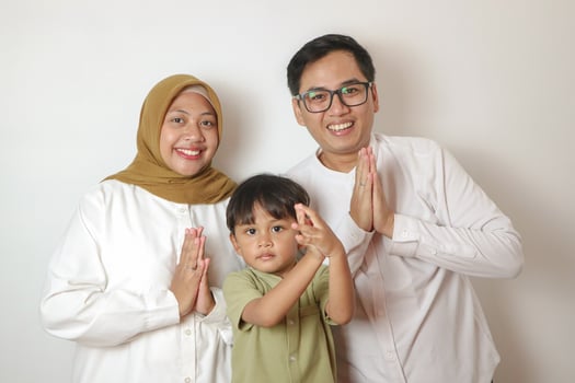 Happy Muslim children laughing with their parents during Eid Mubarak isolated on white background. photo