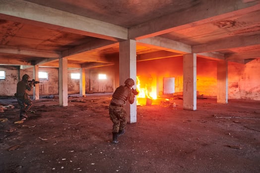 A group of professional soldiers bravely executes a dangerous rescue mission, surrounded by fire in a perilous building. photo