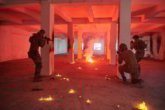 A group of professional soldiers bravely executes a dangerous rescue mission, surrounded by fire in a perilous building. photo