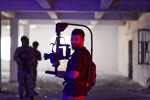 A professional cameraman captures the intense moments as a group of skilled soldiers embarks on a dangerous mission inside an abandoned building, their actions filled with suspense and bravery photo