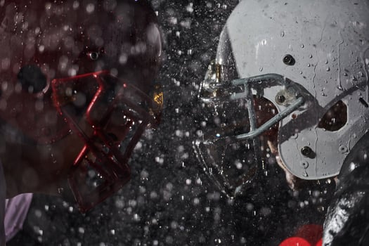 Two american football players face to face in silhouette shadow on white background photo