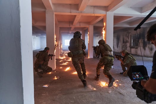 A professional cameraman captures the intense moments as a group of skilled soldiers embarks on a dangerous mission inside an abandoned building, their actions filled with suspense and bravery photo