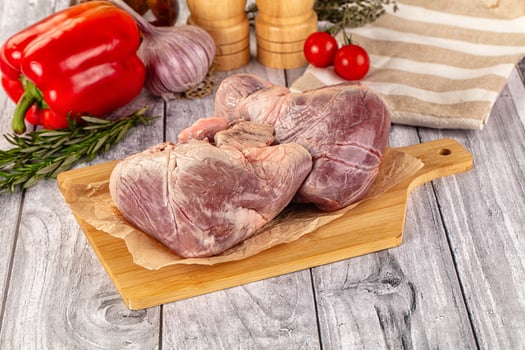 A cutting board with two raw meat on it photo