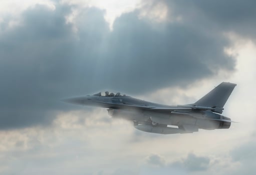 A fighter jet flying through the sky photo