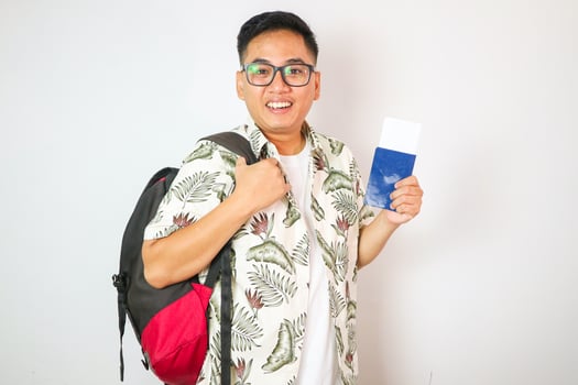 close up young asian man smile and looking while holding passport ,ticket and smartphone in airport departure area for traveling and people lifestyle concept photo