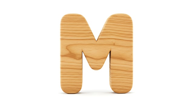 Wooden Letter M Stands Against a White Backdrop in Focus photo