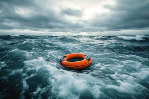 Dark stormy waters with an orange life ring in the ocean photo