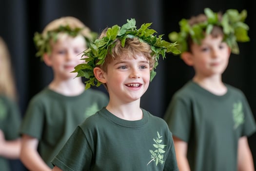 Young children wearing green wreaths on their heads photo