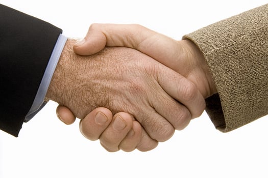 Two people shaking hands on a white background photo