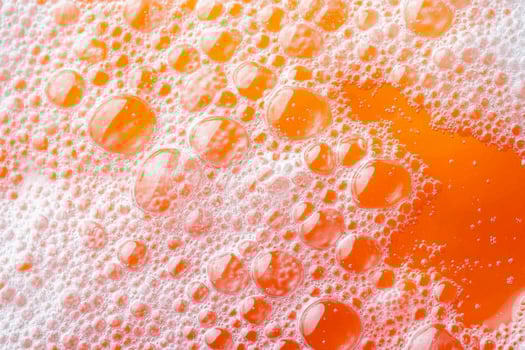 Orange bubbles in a bath of soap photo