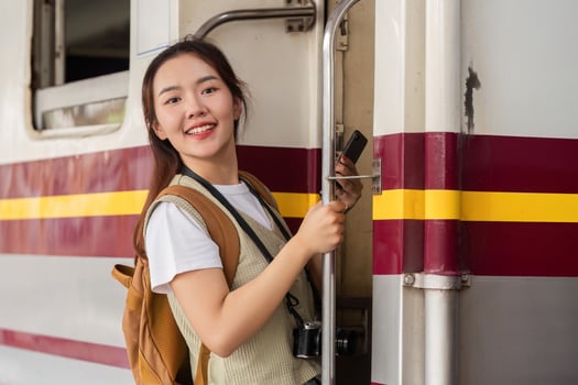 Travel and New Beginnings. A woman confidently boards a train, ready for her journey. photo