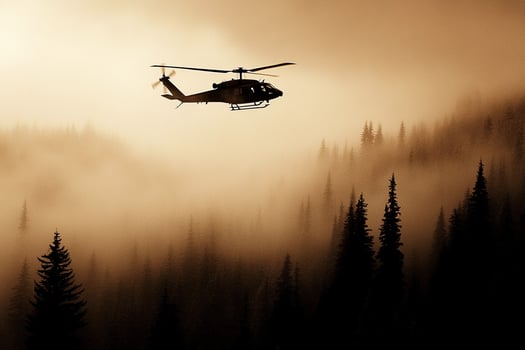 A helicopter flying over a foggy forest photo