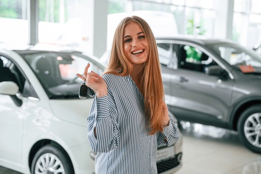New owner, of the car. With keys in hands. Beautiful woman is indoors photo