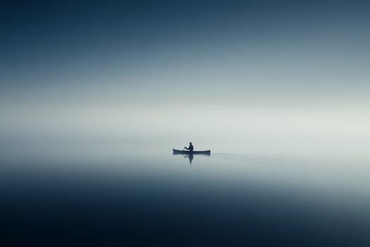 A man in a boat on a calm lake photo
