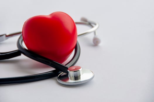 Close up view of stethoscope with red hearts shape on white background with customizable space for text. Medical and health concept. photo