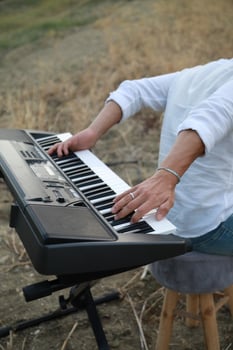 Boy Plays The Keyboard Backwards In The Nature Outdoor photo