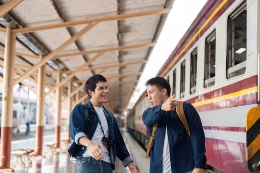 Travel Enthusiasm and Joyful Conversations. Two friends chatting about their travel plans at the train station. photo