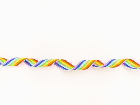 Rainbow cloth ribbon on a white background. Close-up photo