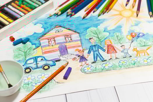 Hand drawn Bright Childrens Sketch With Happy Family, House, Dog, Car on the Lawn with Flowers with lying pencils and pastel - concept of children creativity, close up perspective view photo