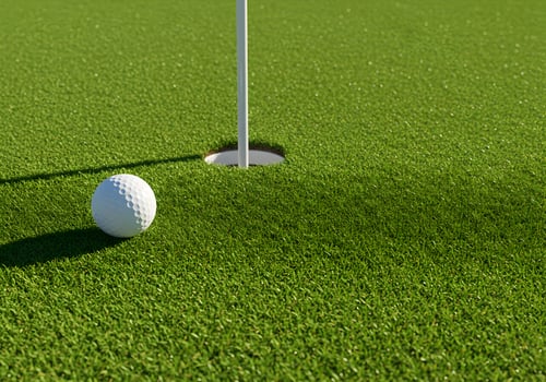 Golf Ball on the Green, Close to the Hole photo