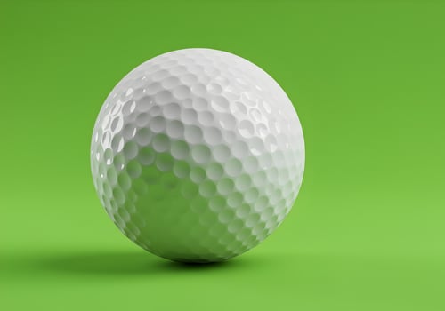 Close up of a Golf Ball on a Green Background photo