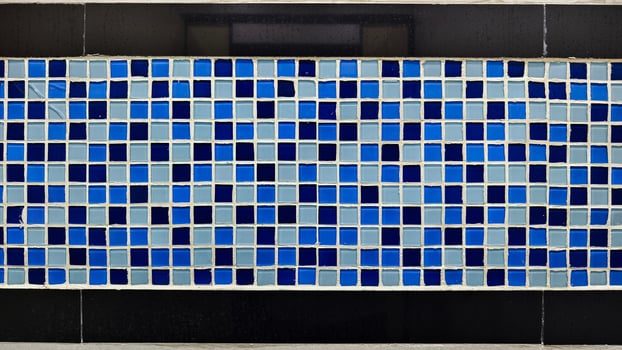 Vibrant Blue and Light Blue Mosaic Wall with Geometric Tile Design. photo