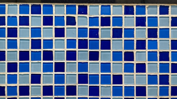 Vibrant Blue and Light Blue Mosaic Wall with Geometric Tile Design photo