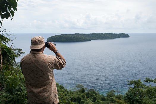 A man taking a picture of a body of water photo