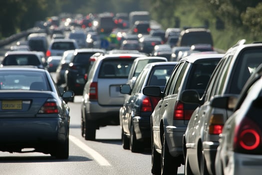 Many cars are driving on the road photo