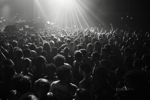 A large gathering of concertgoers engage passionately at a live music event, immersed in the atmosphere created by the lighting photo