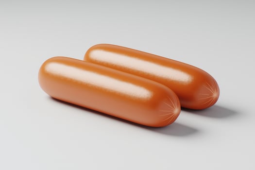 Two perfectly cooked sausages rest on clean surface, showcasing appetizing appearance photo