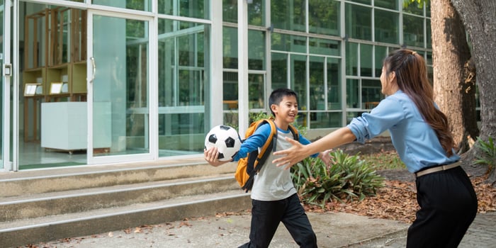 Soccer Celebration and School Memories. A boy excitedly runs to his mother after school. photo