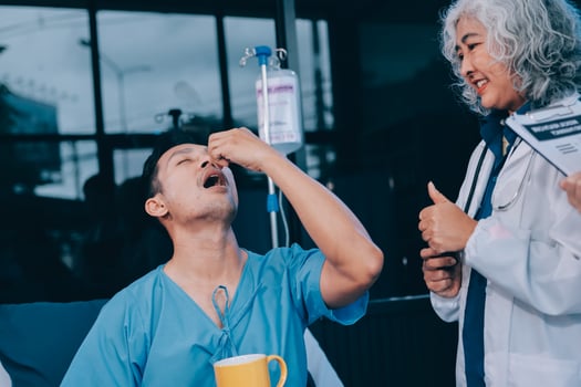 A nurse giving a patient a cup of coffee photo