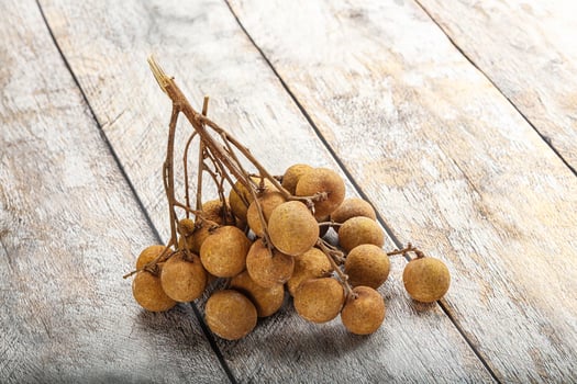 A bunch of dried fruit on a wooden table photo