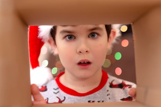 The shock of emotion in a boy in a New Year's jumper and a hat of Santa Clau photo