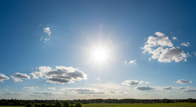 Warm spring weather with sunbeams and cloudless blue sky shining over a blooming green countryside photo