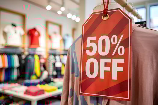 50 percent off discount sign hanging in fashion retail store photo