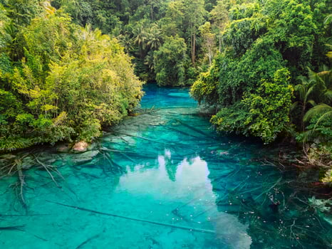 Transparent lake with crystal water. Remote destination in Indonesia, new tourist attraction. Aerial view photo